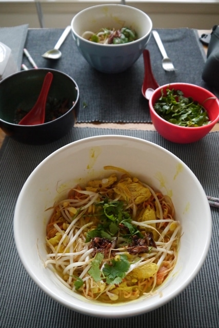 Who can resist Khao Soi with Chicken? Cozy egg noodles, creamy coconut milk broth dyed a bright, happy yellow from the turmeric, which has healing properties in it and so does the ginger!!, plus FRIED shallots sprinkled on top? Coziness and happiness all in one bowl! | thai-foodie.com