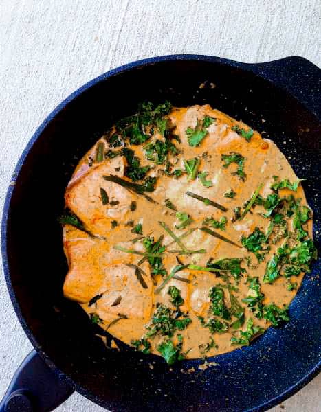 Quick Thai Salmon Red Curry is the perfect weeknight meal since it's full of flavor and only takes 30 minutes! Can it get more delicious?? Salmon, kale, Thai red curry paste, and coconut milk! Such a heartwarming treat to get you through your week! SO good! | thai-foodie.com